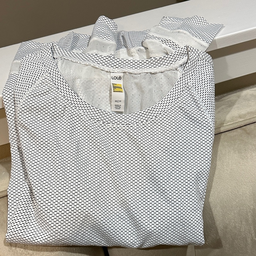 Lole White Sport Tee with Black Micro-Dash Pattern Mesh details.